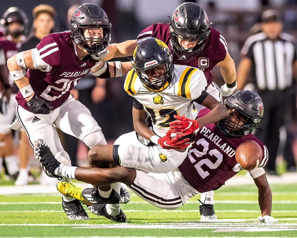 HASTINGS FUMBLES BALL - Pearland's Cole Anderson (20) and Lazarus Range (22) force a fumble by Hastings Omar Abdule (12) which was recovered by Range. The Oilers thrashed the Bears 59-7 in the final game of the regular season. Pearland (6-4) will face the Dickinson Gators (7-3) on Friday, November 11 at 7:00 p.m. in the 6A Region III Div I bi-district playoffs at The Rig. (Photo by Olyn Taylor)