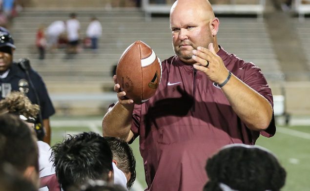 100th WIN - Pearland head football coach Ricky Tullos was presented the game ball following the Oilers' 49-23 victory over the Spring Branch Memorial Mustangs. Pearland principal John Palombo presented the ball to Tullos to celebrate his 100th career win as a head football coach. He has a career mark of 100-28 and counting. (Photo by Lloyd Hendricks)