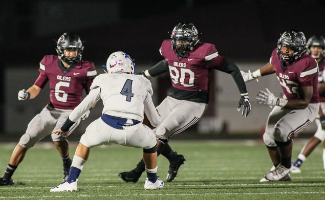 NO PLACE TO GO - The Pearland defense has played stellar all season as seen on this play against Brazoswood when Bucs quarterback Lane Caballero (4) found himself surrounded by Pearland's Devin Linton (6), Tre'Vonte White (90), and Isaiah Iton (42) that resulted in loss yardage. Brazoswood was held to only 27 yards rushing and 180 total yards in the 55-7 district beat down. (Photo by Lloyd Hendricks)