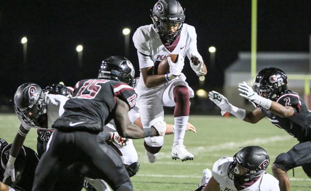 LEAPING INTO THE END ZONE - Pearland all-purpose athlete Austin Landry (10) leaps through a hole for a 4-yard touchdown to give the Oilers a 14-0 lead against George Ranch. Pearland beat the Longhorns 28-7 to complete the 2018 regular season with a perfect 10-0 mark. Landry also scored on a 2-yard run. The Oilers will host the Dickinson Gators at The Rig on Friday, November 16 at 7:00 p.m. in the bi-district Class 6A Div. I Region III playoff game. (Photo by Lloyd Hendricks)
