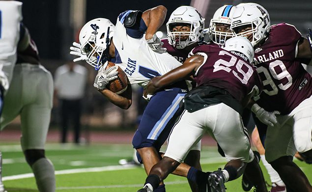 PEARLAND DEFENSE - Pearland limited Alief Elsik to only six points in the Oilers' 42-6 homecoming win. Ian Ejedepang-Koge (29) and Elijah Cavitt-Holbert (99) and others stopped wide receiver Adryan Brown (4) on this play. (Photo by Lloyd Hendricks)